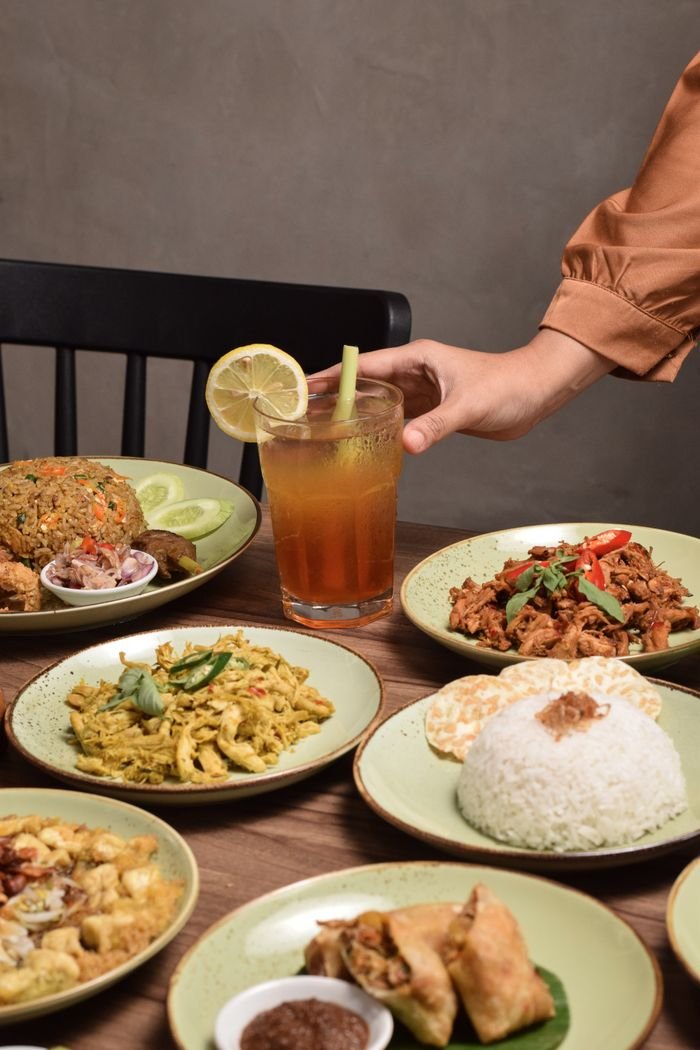 A variety of traditional Indonesian dishes served indoors in Jakarta.